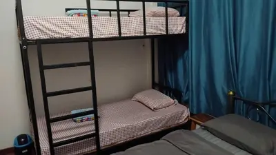 a room with two bunk beds with a ladder at Sleepwith me Hostel in Bangkok
