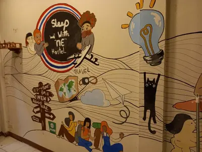 a mural of a group of people on a wall at Sleepwith me Hostel in Bangkok