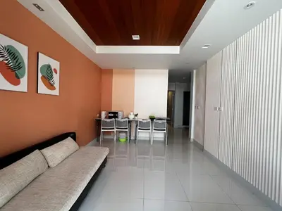 a living room with a couch and a table at Smile Residence at Kaset-Sena in Ban Yang