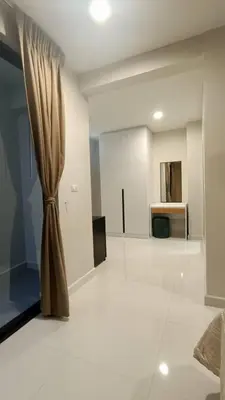 a living room with a curtain on the floor at Smile Residence at Kaset-Sena in Ban Yang