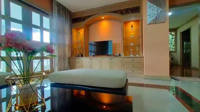 a large living room with a bench and a television at Smile Residence at Kaset-Sena in Ban Yang