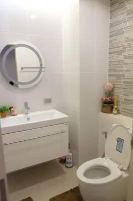 a bathroom with a toilet and a sink and a mirror at HIGH RISE LUXURY CONDO 1BED ROOF TOP POOL 2 MinMRT in Bangkok