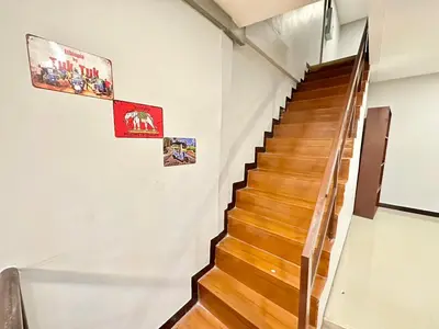 a staircase in a building with posters on the walls at Baan at Khaosan Hostel in Bangkok
