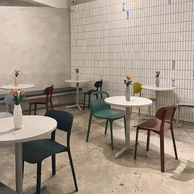 a room with tables and chairs with flowers on them at E11 Hotel - BTS Punnawithi in Amphoe Phra Khanong