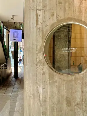 a building with a round window on a wall at E11 Hotel - BTS Punnawithi in Amphoe Phra Khanong