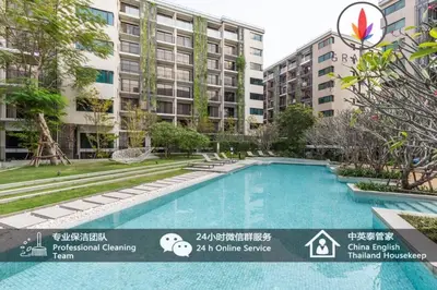 a swimming pool in front of a building at BTS S5 Surasak 900 meters near the Mekong River Pier Free Swimming Pool in Ferris Wheel Night Market Chinese Reception Bangkok Center in Lat Krabang