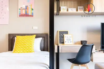 a bedroom with a bed and a chair next to a desk at BTS S5 Surasak 900 meters near the Mekong River Pier Free Swimming Pool in Ferris Wheel Night Market Chinese Reception Bangkok Center in Lat Krabang