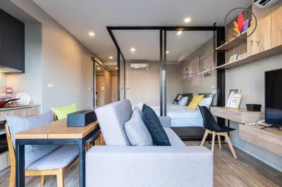 a room with a bed and a couch and a table at BTS S5 Surasak 900 meters near the Mekong River Pier Free Swimming Pool in Ferris Wheel Night Market Chinese Reception Bangkok Center in Lat Krabang