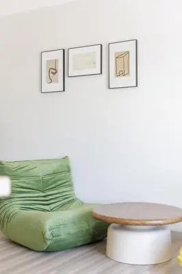 a coffee table and a green couch in a room at Advanced townhouses can accommodate 14 people, with high-speed Wi Fi and parking on Netflix in Ban Non Yang Ngam