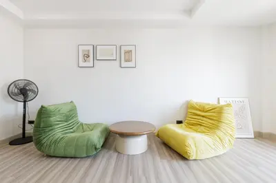 two chairs and a table in a room at Advanced townhouses can accommodate 14 people, with high-speed Wi Fi and parking on Netflix in Ban Non Yang Ngam