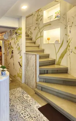 a staircase in a room with a mural of flowers at Suraya Bangkok in Bangkok