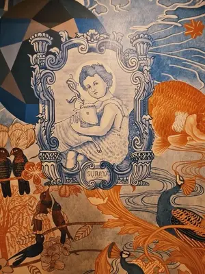 a painting of a woman holding a pot on a wall at Suraya Bangkok in Bangkok