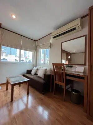 a living room with a couch and a table at Jhouse Thonglor in Khlong Toei
