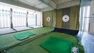 an inside view of a batting cage with a putting green at Citiresort Living sukhumvit 39 in Makkasan
