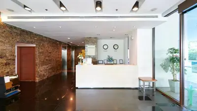a lobby of a building with a reception counter at Citiresort Living sukhumvit 39 in Makkasan
