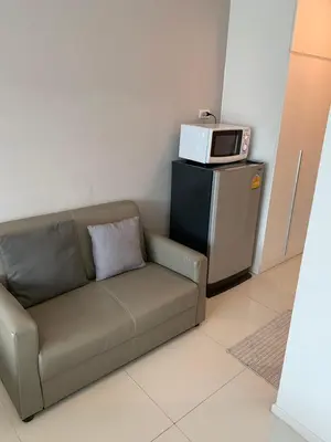 a couch with a microwave on top of a refrigerator at 2 mins walk to BTS Bang Chak in Bangkok