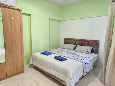 a bedroom with a bed with two blue pillows on it at Cozy 1br walk to BTS and Airport Rail Link Close to Malls m11 in Bangkok