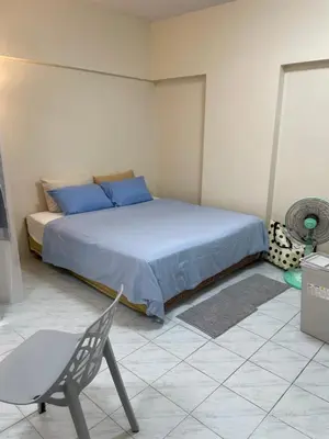 a bedroom with a bed and a chair in it at Cozy 1br walk to BTS and Airport Rail Link Close to Malls m11 in Bangkok