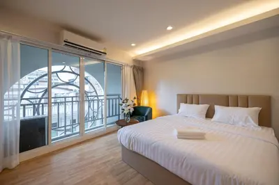 a bedroom with a bed and a large window at Exoresidence The Heart of Chinatown in Bangkok