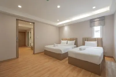 a hotel room with two beds and a mirror at Exoresidence The Heart of Chinatown in Bangkok