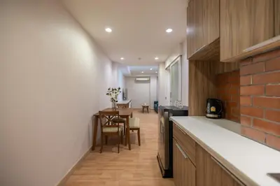 a kitchen with a counter and a dining room at Exoresidence The Heart of Chinatown in Bangkok