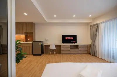 a living room with a bed and a television at Exoresidence The Heart of Chinatown in Bangkok