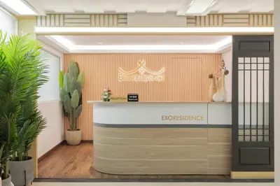 an office lobby with a reception desk and plants at Exoresidence The Heart of Chinatown in Bangkok