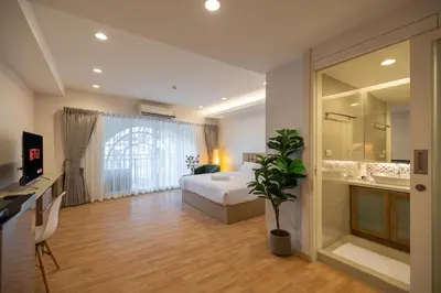 a hotel room with a bed and a bathroom at Exoresidence The Heart of Chinatown in Bangkok
