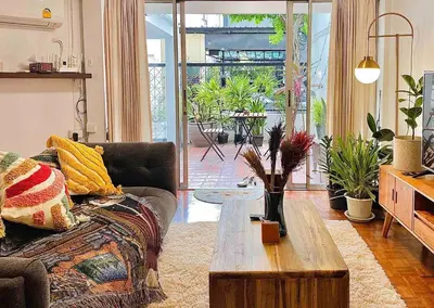 a living room with a couch and a coffee table at Flip Flop In Townhouse in Bangkok