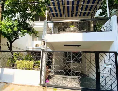 a dog in a cage in a building at Flip Flop In Townhouse in Bangkok
