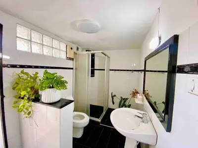 a bathroom with a sink and a toilet with plants at Flip Flop In Townhouse in Bangkok
