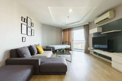 a living room with a couch and a flat screen tv at Internet celebrity train night market swimming pool free WiFi mrt 100m in Ban Tha Satu