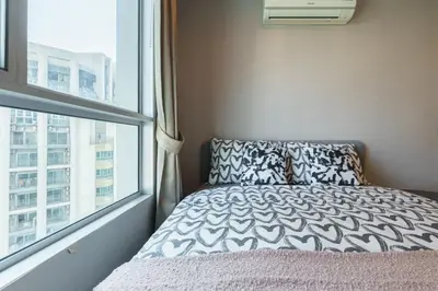 a bedroom with a bed and a large window at Internet celebrity train night market swimming pool free WiFi mrt 100m in Ban Tha Satu