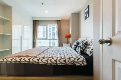 a bedroom with a bed and a window at Internet celebrity train night market swimming pool free WiFi mrt 100m in Ban Tha Satu