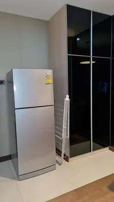 a white refrigerator in a room with a glass door at 1BR Thonglor , Fast WiFi , Near Samitivej , Nightlife in Khlong Toei