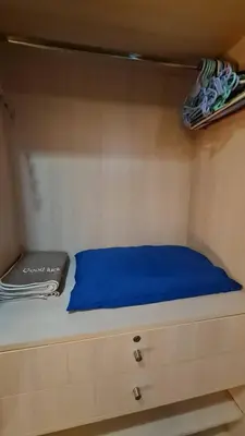 a bed in a small room with a blue blanket at 1BR Thonglor , Fast WiFi , Near Samitivej , Nightlife in Khlong Toei