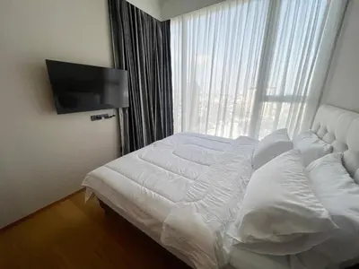 a white bed in a room with a window at 2 Bedroom Luxury Apartment 3 min walk from BTS Ekkamai in Bangkok