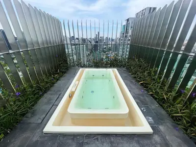 a bath tub on the roof of a building at 2 Bedroom Luxury Apartment 3 min walk from BTS Ekkamai in Bangkok
