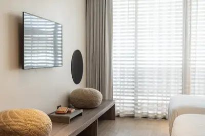 a bedroom with a bed and a large window at Stay Plus Hotel Bangkok in Bangkok