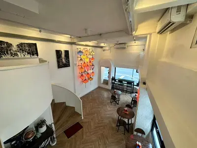 an overhead view of a living room and a dining room at The White Den Sukhumvit 44 in Bangkok