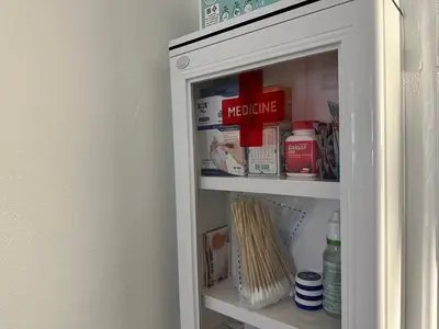 a medicine cabinet in a room with medicines at The White Den Sukhumvit 44 in Bangkok