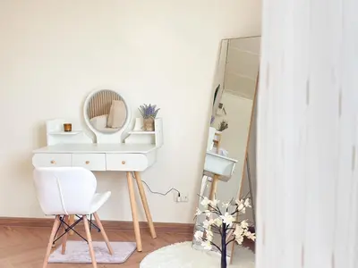 a dressing room with a mirror and a white dressing table at NK hostel in Thung Si Kan