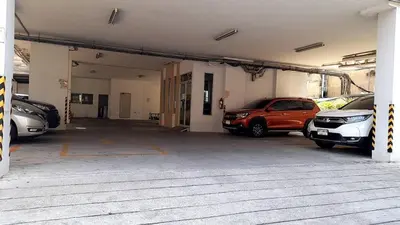 a garage with several cars parked in it at Love mansion in Bangkok