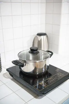 a pot on top of a stove in a kitchen at Baan Khun Pra APT No4 Duplex 3BR in Bangkok