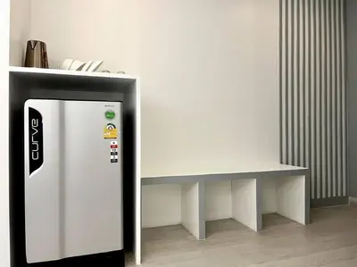 a white refrigerator next to a white table at DiscoveryHome2 at Pratunammarket in Bangkok