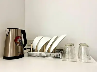 a kitchen counter with a blender and two glasses at DiscoveryHome2 at Pratunammarket in Bangkok