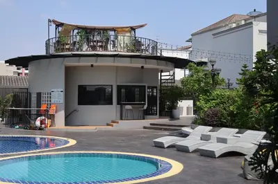 a building with a balcony and a swimming pool at Shewin de Bangkok in Ban Bang Bamru
