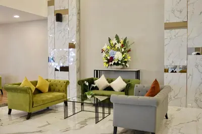 a living room with two couches and a table at Shewin de Bangkok in Ban Bang Bamru