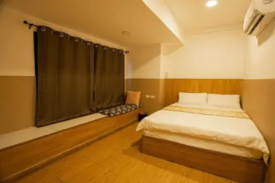 a small bedroom with a bed and a window at Dado9home in Khlong Toei