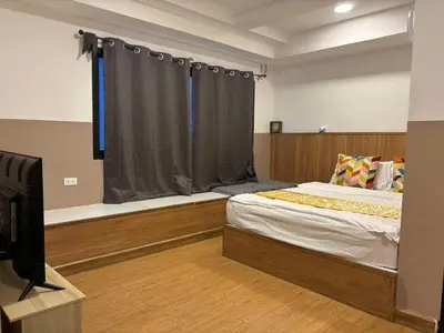 a bedroom with a bed and a tv and a window at Dado9home in Khlong Toei
